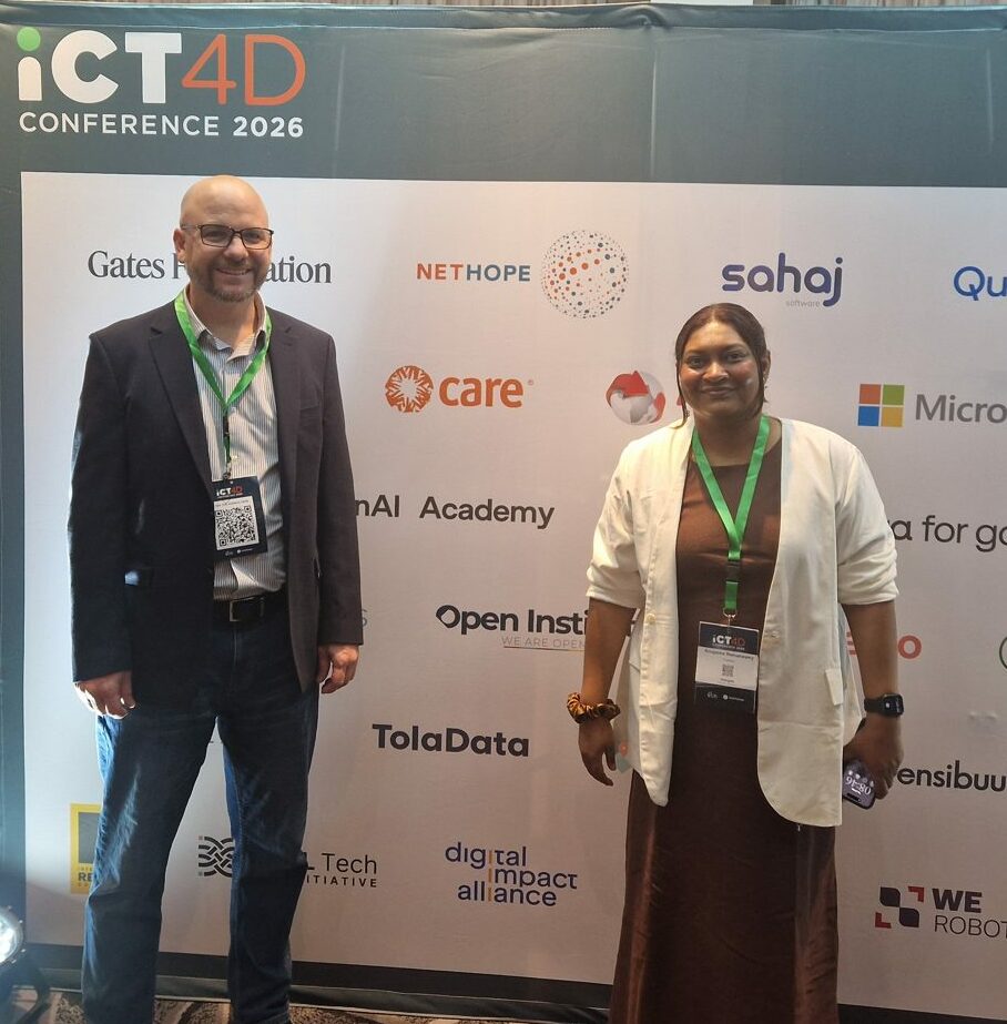Yazeed Sheqem and Anupama Ramaswamy at the ICT4D 2026 sponsor board in Nairobi, featuring the TolaData logo